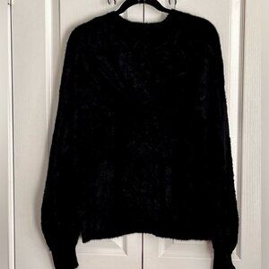 Modern cardigan sweater, soft fuzzy textured, V-neckline.